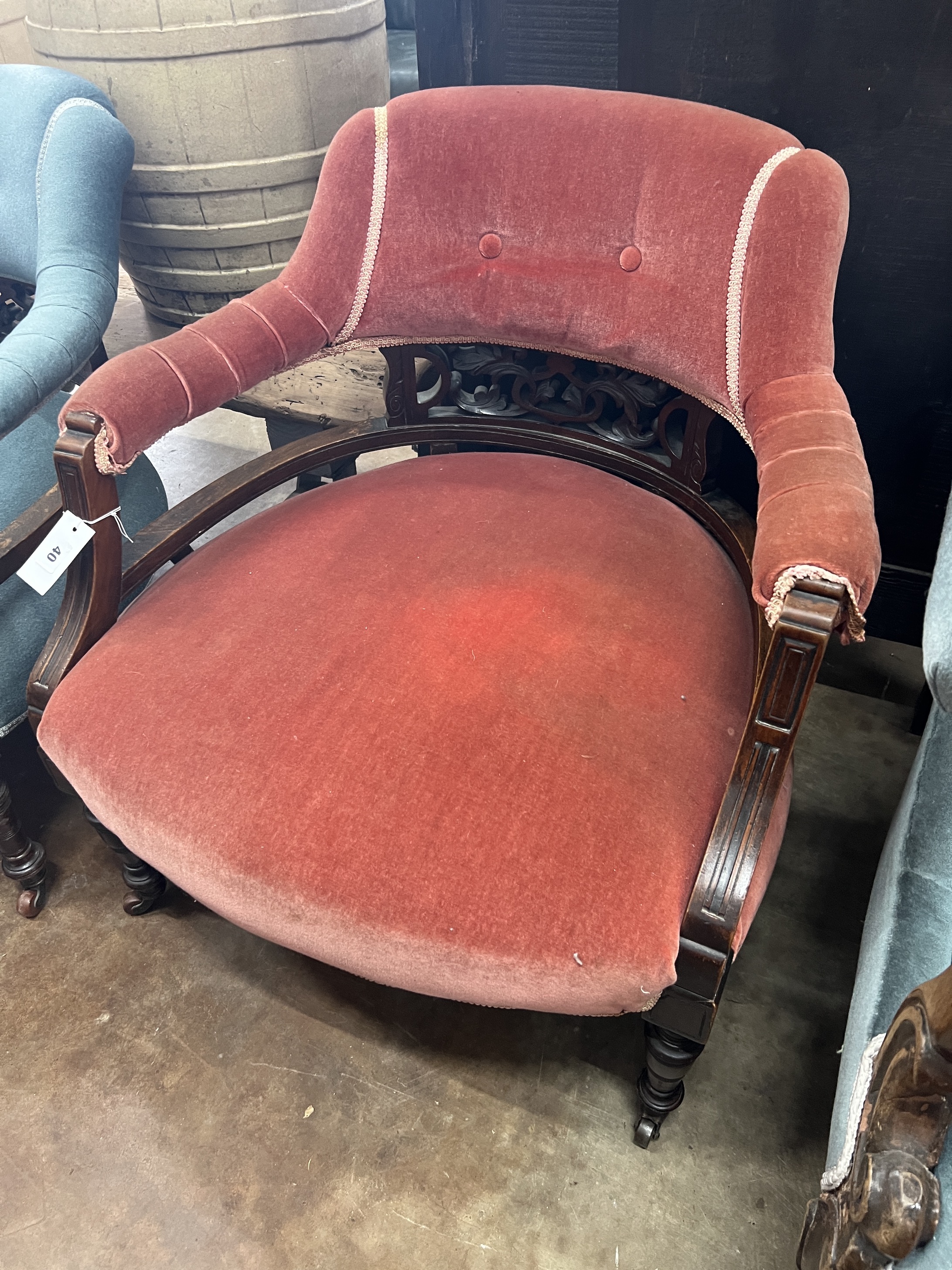 A pair of late Victorian tub shaped open armchairs, upholstered, one in red, the other in blue, width 68cm, depth 58cm, height 72cm